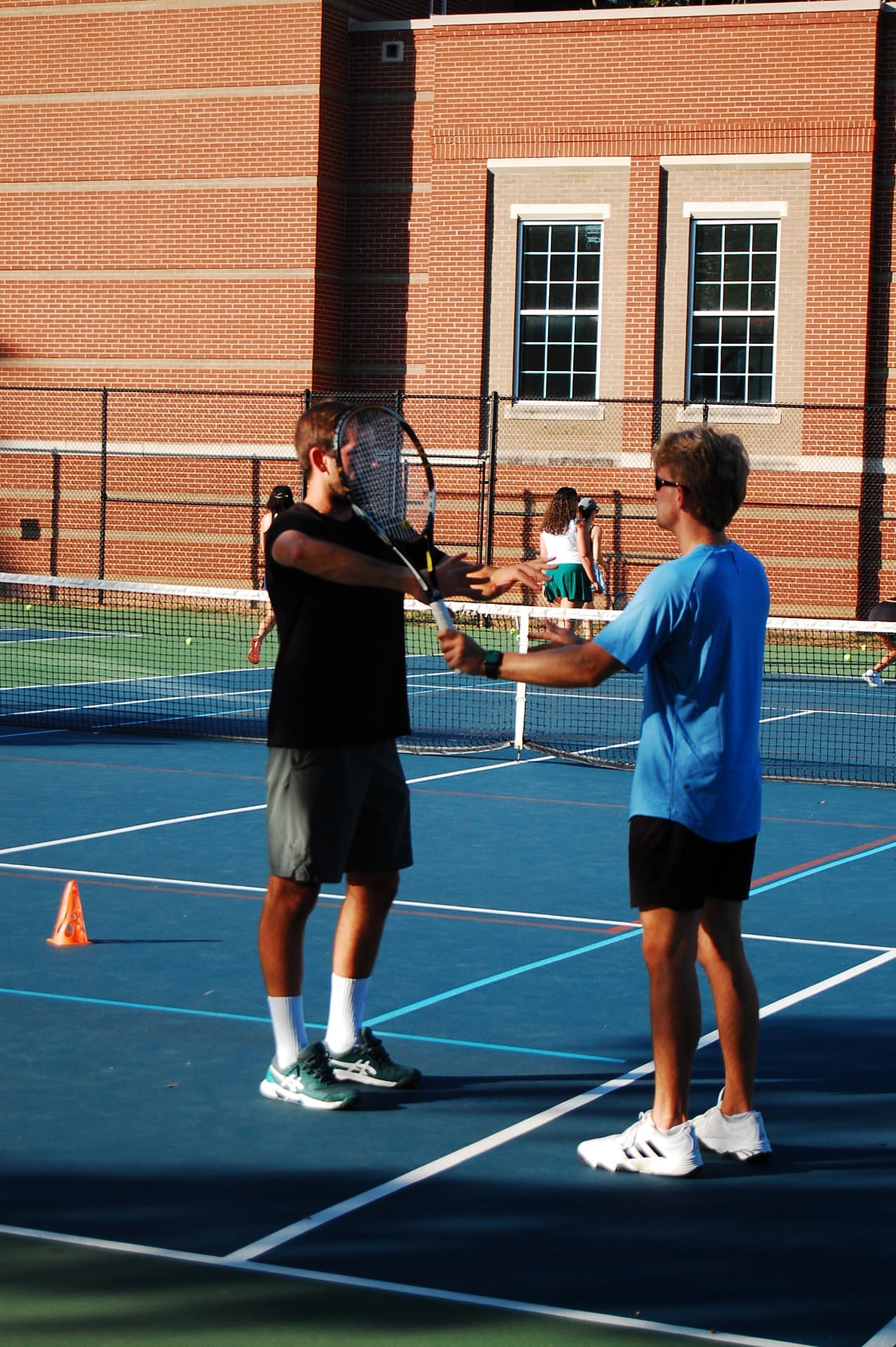 A coach working on a forehand with a Tardeo player