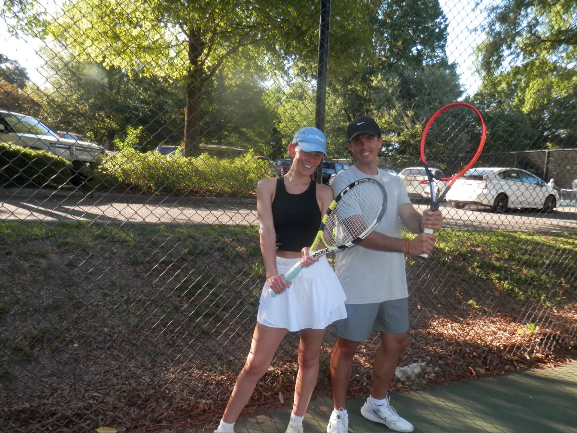 Two Tardeo players with rackets courtside