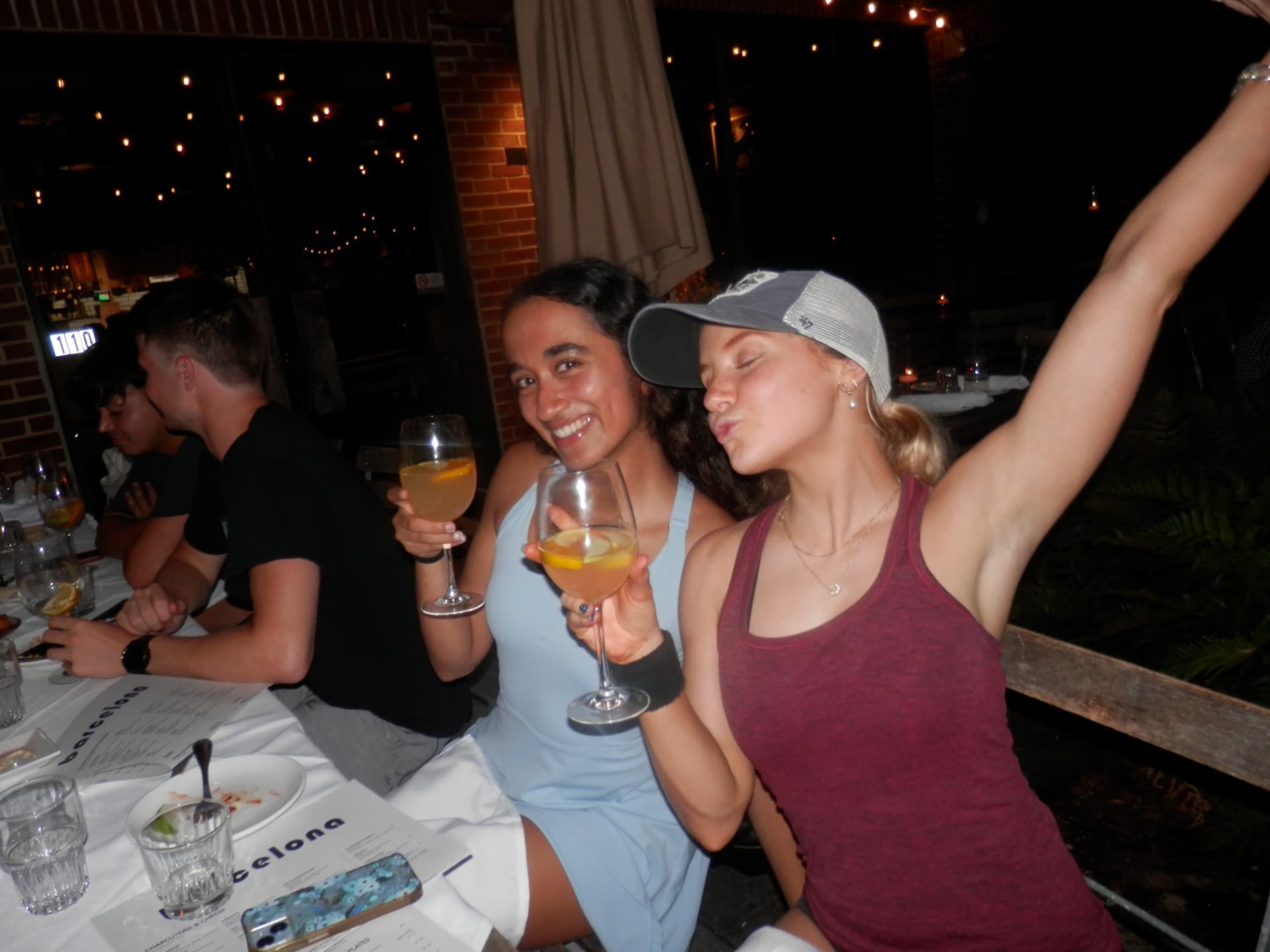Two Tardeo players celebrating with wine after tennis