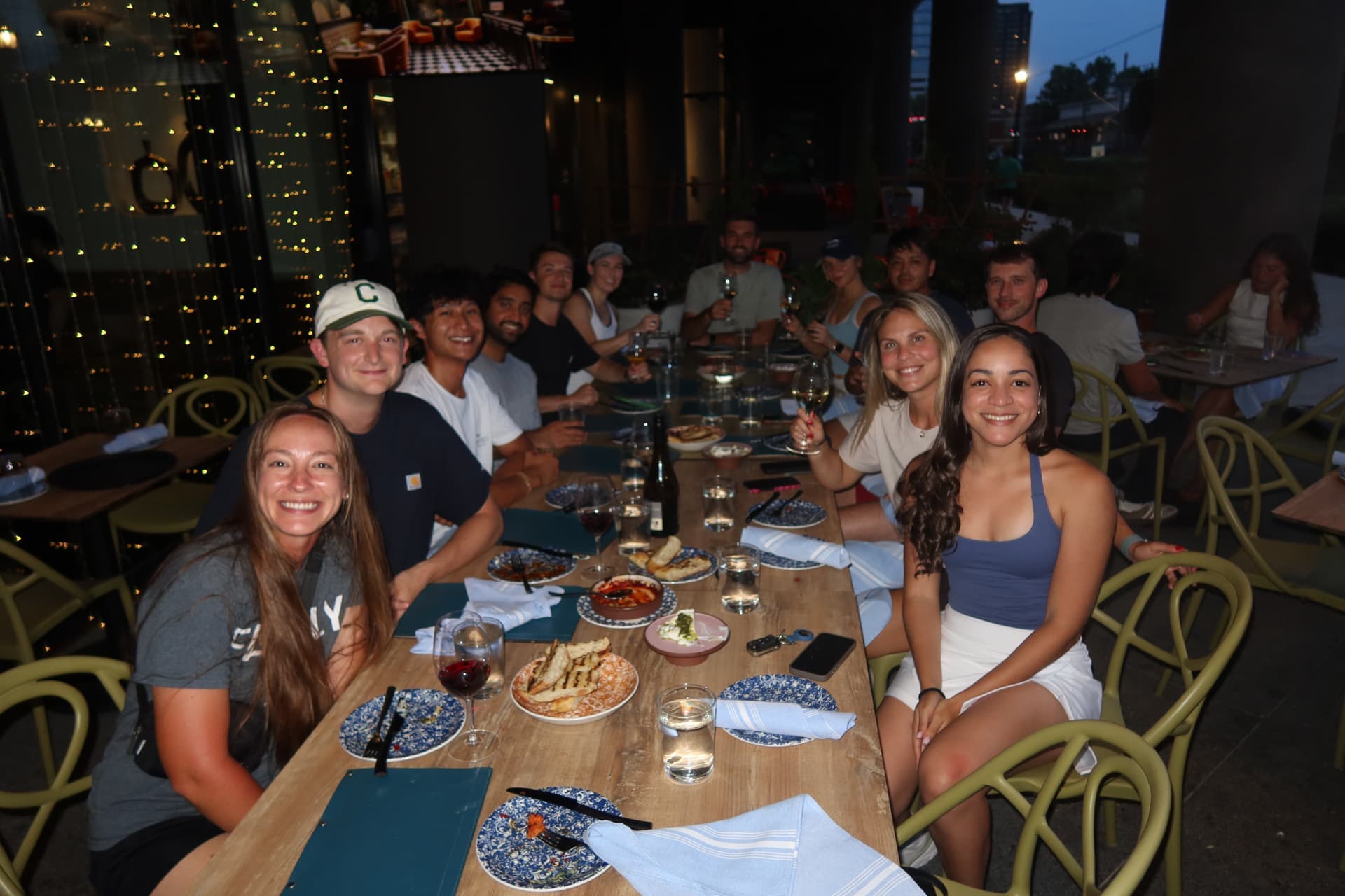Tardeo group around a long dinner table with tapas and wine